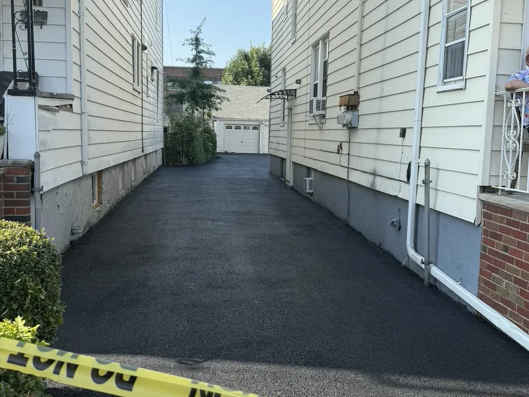 Sealed residential asphalt driveway in a New Jersey neighborhood